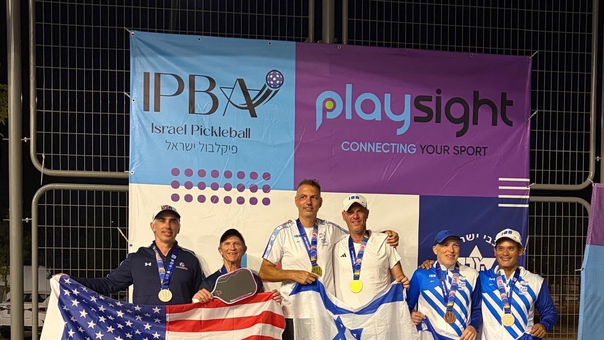 Medal podium at the World Maccabi Games pickleball competition, with USA and Israel flags
